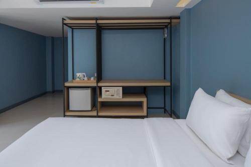 a blue room with a bed and a table at Nora LakeView in Chaweng