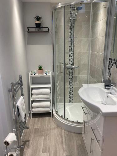 a bathroom with a shower and a sink at The Penthouse - Luxury 2 Bed Apartment in Skegness