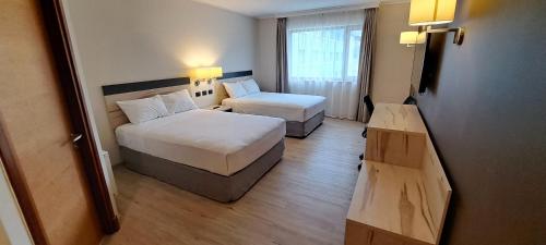 Ένα ή περισσότερα κρεβάτια σε δωμάτιο στο Hotel Diego de Almagro Castro