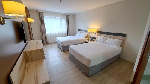 Postel nebo postele na pokoji v ubytování Hotel Diego de Almagro Castro