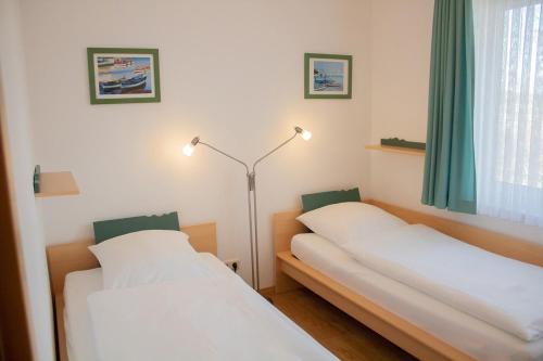 מיטה או מיטות בחדר ב-KD16-69 - Ferienwohnung Standard