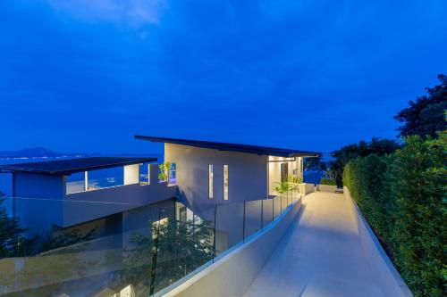 a house with a long walkway at night at Luxurious Villa Anushka - breathtaking sea views and dedicated housekeeping staff in Chaweng Noi Beach
