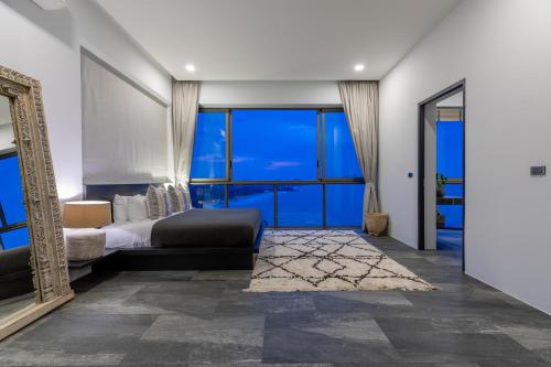 a bedroom with a bed and a large mirror at Luxurious Villa Anushka - breathtaking sea views and dedicated housekeeping staff in Chaweng Noi Beach