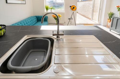 a kitchen sink with a faucet in a kitchen at Ansley house in Arley