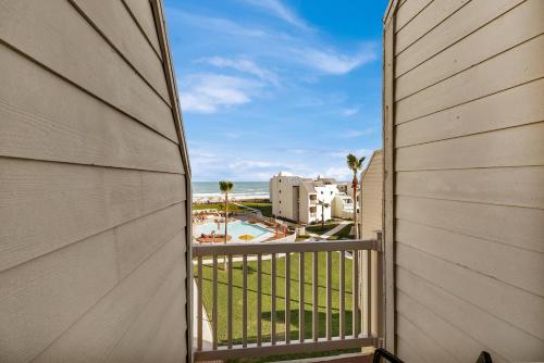 a balcony with a view of the beach and buildings at Ocean view with easy beach access in South Padre Island