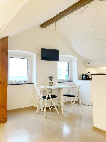 a kitchen and dining room with a table and chairs at La Finestra Sull’Oasi in Genoa