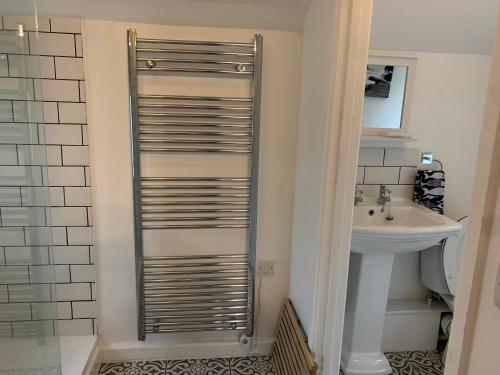 a bathroom with a toilet and a sink at Spacious 1 bedroom cottage between coasts in North Hill