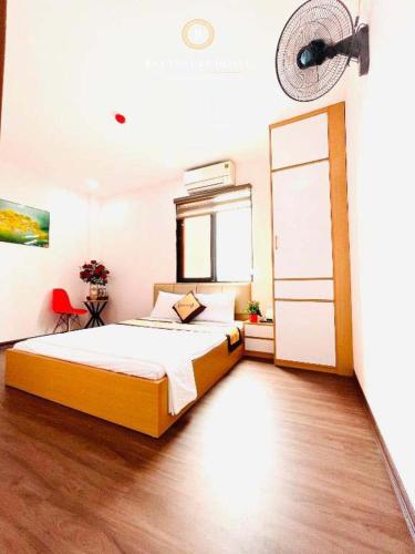 a bedroom with a bed and a fan on the wall at A&EM VILLA HN - by BAY LUXURY in Hanoi