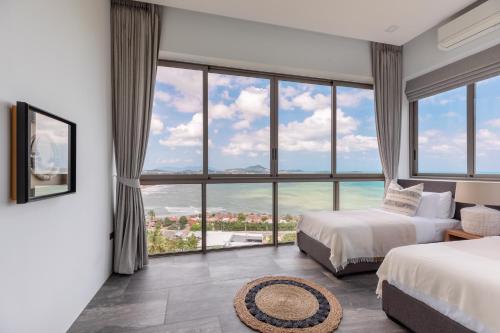 a bedroom with two beds and a large window at Villa Anushka - Modern luxury villa with picture-perfect sea views in Koh Samui 