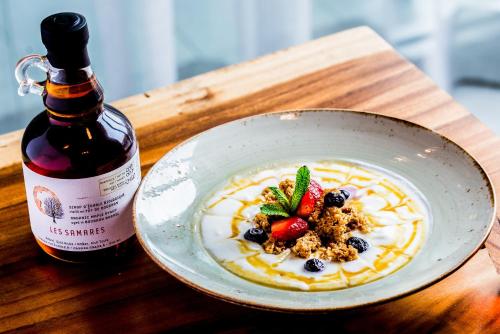 a bowl of food next to a bottle of wine at Delta Hotels by Marriott Trois Rivieres Conference Centre in Trois-Rivières