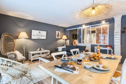 a living room with a table with food on it at Résidences Alticimes in Brides-les-Bains