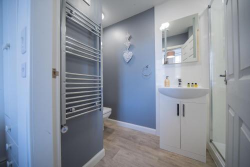 a bathroom with a white sink and a toilet at Double Ensuite Bedroom near Edinburgh in Kirkcaldy