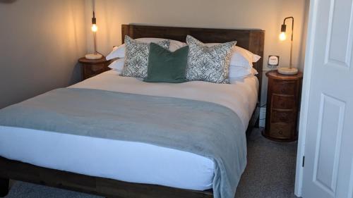a bedroom with a large bed with pillows at Oaklands Guest House in Weymouth