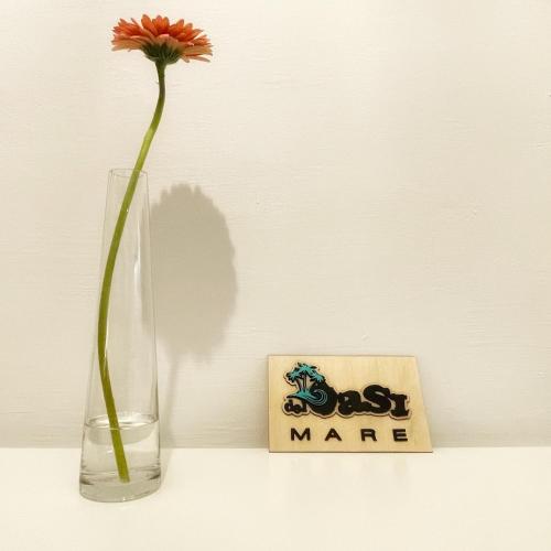 a vase with a flower in it next to a best man sign at La Finestra Sull’Oasi in Genoa