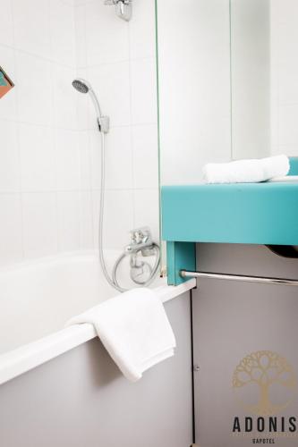 a bathroom with a shower and a blue sink at Adonis Gapotel in Gap