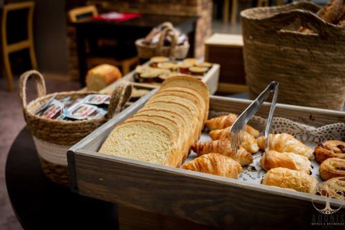 a tray of bread and pastries on a table at Adonis Gapotel in Gap