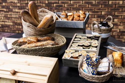 a table topped with baskets of bread and pastries at Adonis Gapotel in Gap