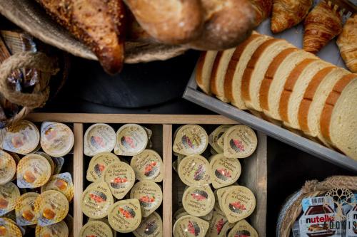 a display of different types of breads and pastries at Adonis Gapotel in Gap