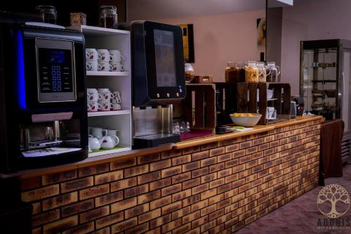 a brick counter with microwaves on top of it at Adonis Gapotel in Gap