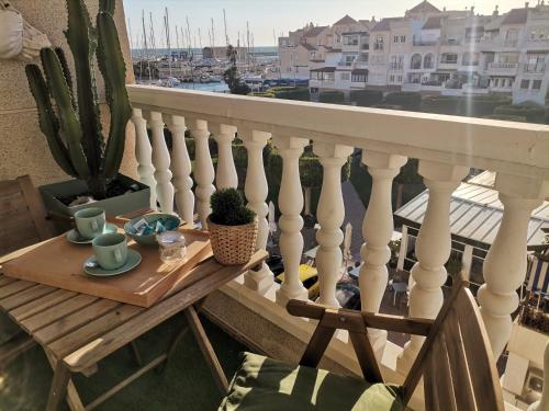 a table on a balcony with a view of the harbor at Villa Pepita in Almerimar