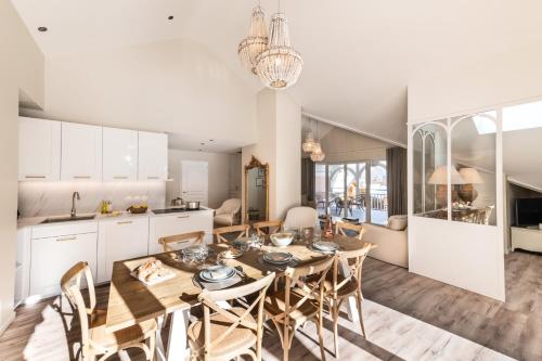 a kitchen and dining room with a table and chairs at Résidences Alticimes in Brides-les-Bains