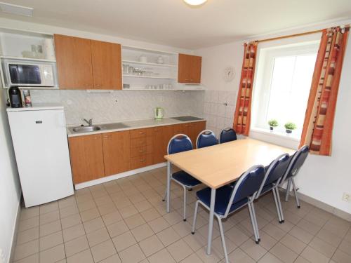 a kitchen with a table and chairs and a refrigerator at Holiday Home Holiday Hill by Interhome in Černý Dŭl