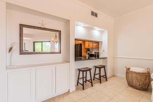 cocina con barra con taburetes y espejo en 7135 Harbourside II In the heart of dining and shopping Harbour View Sleeps 4 Shelter Cove, en Hilton Head Island