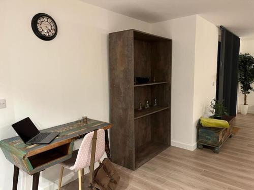 a desk with a laptop on it in a room at Bayard Luxe 2 Bedroom Penthouse Duplex in Peterborough