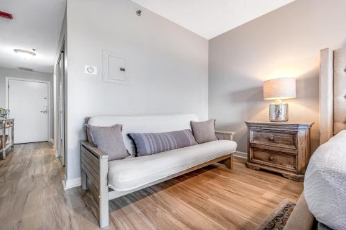 a bedroom with a couch and a bed and a table at TOPS'L Summit 706 A in Destin