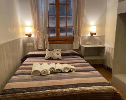a bedroom with two beds with towels on it at HOTEL LAMOGA in Llavorsí