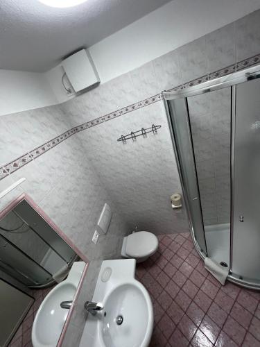 a bathroom with a toilet and a sink and a shower at Apartment Cornicello with pool by Glam in Bardolino
