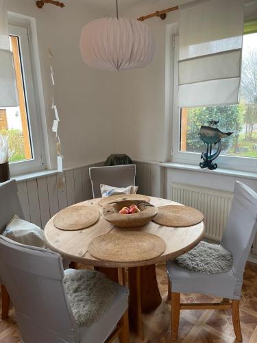 a dining room with a wooden table and chairs at Pension Haus Magarethe am Meer Poel in Insel Poel