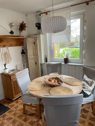 a dining room table with a bowl of fruit on it at Pension Haus Magarethe am Meer Poel in Insel Poel