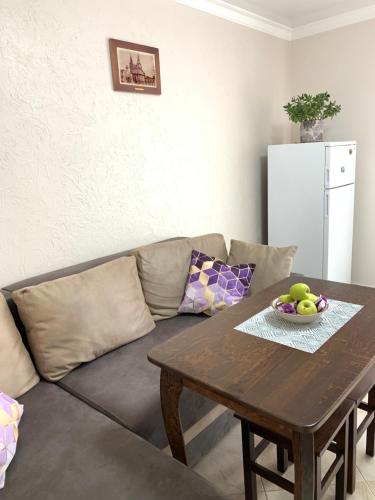 a living room with a couch and a wooden table at Центр. Поруч Парк та Став (3) in Ternopilʼ