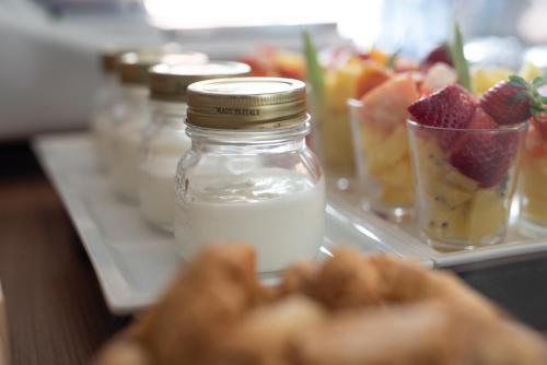 a buffet with fruit and a mason jar of food at Hotel Jolly Roger in Pietra Ligure