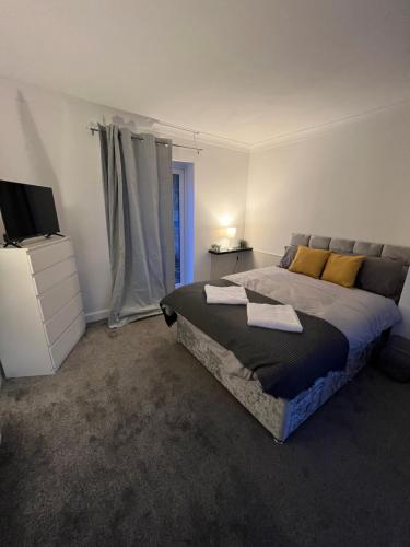 a bedroom with a bed and a television in it at Weardale House in Billingham