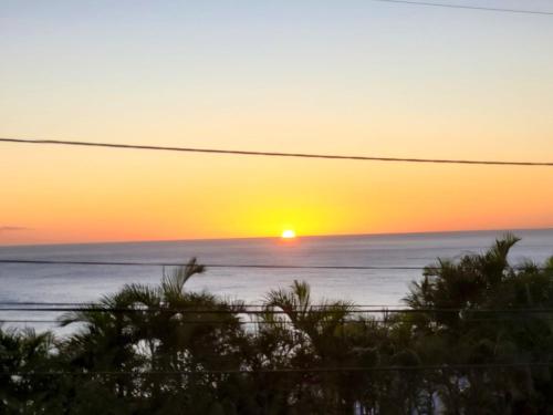 a sunset over the ocean with the sun in the horizon at "Villa confortable proche de Case-Pilote avec piscine privée" in Case-Pilote