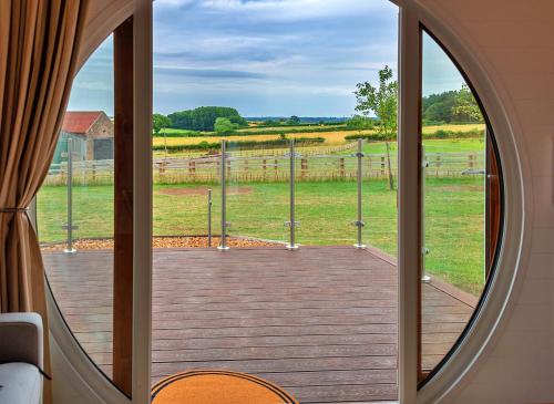 an open door to a deck with a view of a field at Finest Retreats - Deep Dale in York