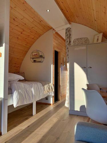 a bedroom with a bed and a wooden ceiling at Finest Retreats - Hundle Dale in York