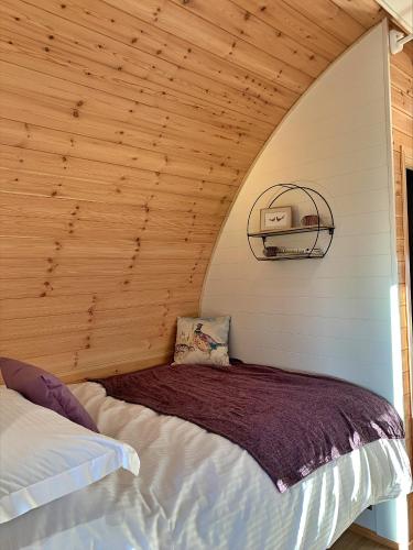 a bed in a room with a wooden ceiling at Finest Retreats - Mingle Dale in York