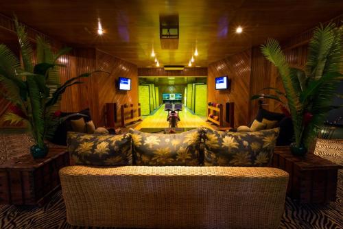 a living room with a couch and a television at Namale All Inclusive Resort & Spa in Savusavu