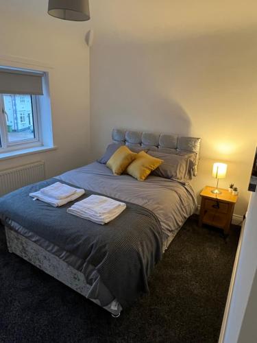 a bedroom with a bed with two towels on it at Weardale House in Billingham