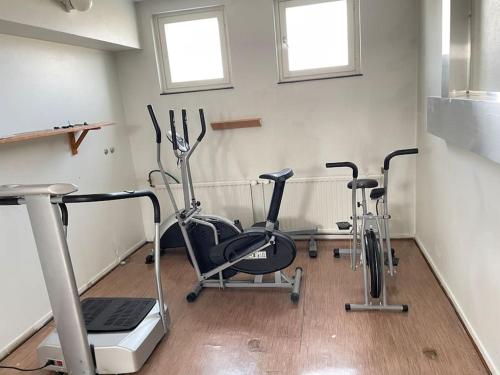 a room with three exercise bikes and a treadmill at Cozy & modern central-apartment in Turku