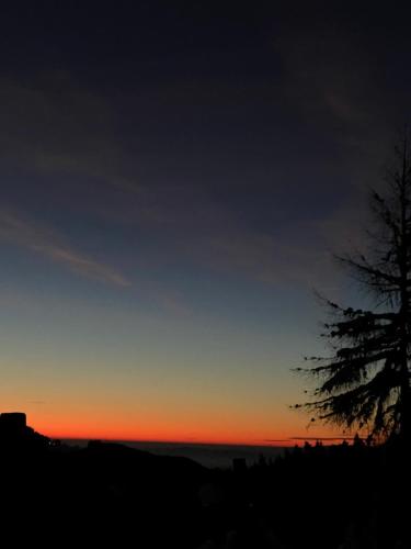 a sunset with a tree in the foreground at Dein HimmelReich - Ruheoase im Almenland auf 1000m über'm Alltag in Kloster