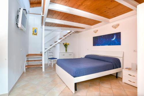 a bedroom with a bed and a staircase at Moon Smile in Massa Lubrense