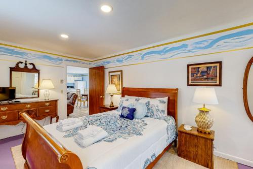 a bedroom with a bed and a desk and a television at Blue Lagoon Escape Unit-B in Boothbay