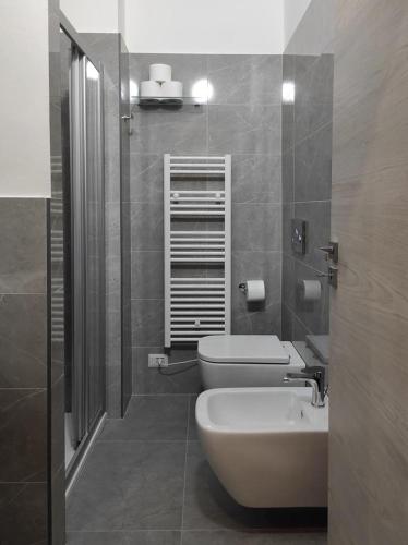 a bathroom with a toilet and a sink at Residenza Via Verdi in Parma