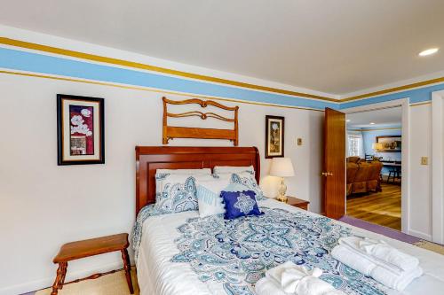 a bedroom with a large bed with blue and white pillows at Blue Lagoon Escape Unit-B in Boothbay
