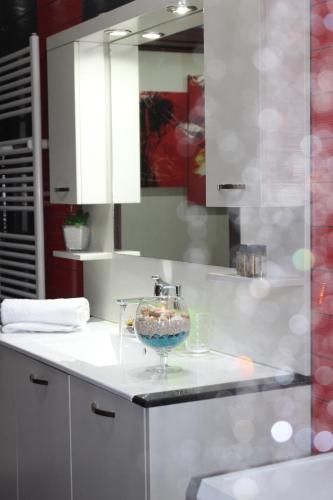 a bathroom with a sink with a bowl on a counter at Kallia's Modern Apartment in Kissamos