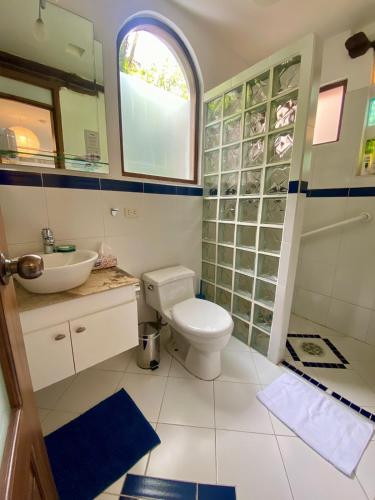 a bathroom with a toilet and a sink at Casa Magnolia in Cumbayá
